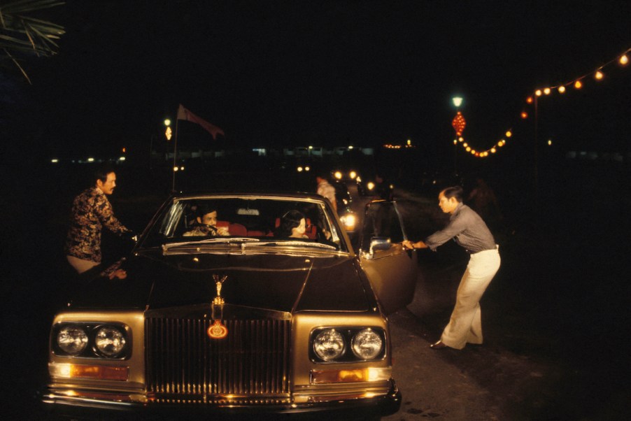 The sultan of Brunei getting into a Rolls-Royce