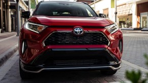 A red 2022 Toyota RAV4 Prime plug-in hybrid SUV is parked.