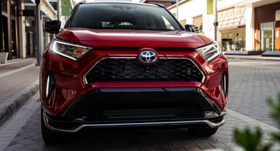 A red 2022 Toyota RAV4 Prime plug-in hybrid SUV is parked.