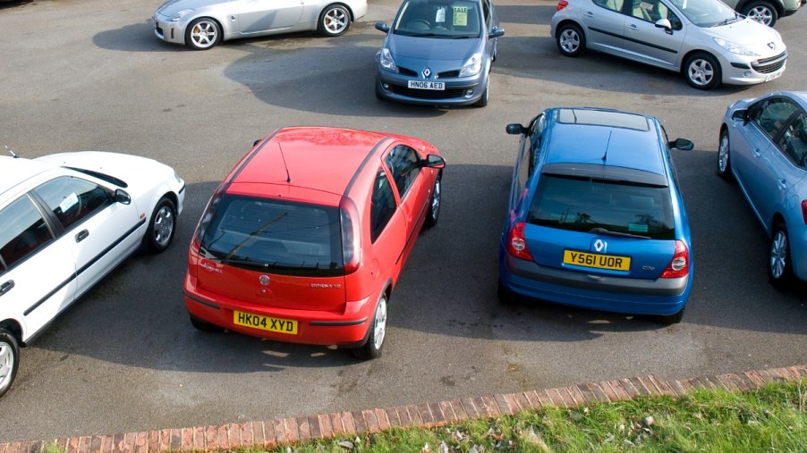 Used cars parked at U.K. dealership, highlighting how used British cars from comedian aid Ukraine's frontline troops