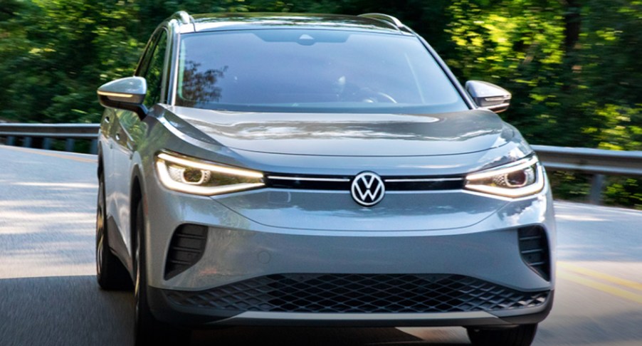 A gray 2022 Volkswagen ID.4 electric SUV is driving on the road.