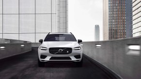 A white 2022 Volvo XC60 Polestar Engineered navigates an urban environoent as a performance SUV.