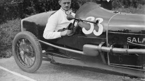 Goldie Gardner in his Salmson GS with an antique car horn accessory at the JCC 200 Mile Race in Brooklands, Surrey