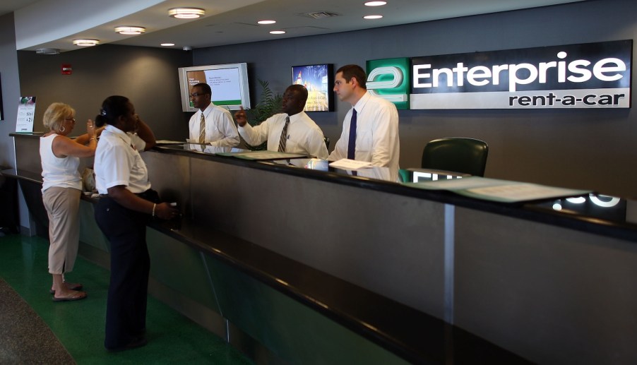 Customer service reps at an Enterprise rental counter.