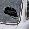 Huge hole with spiderweb cracks in the back windshield of an unidentified car. The hail storm in Florida caused significant damage