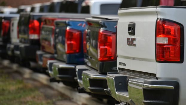 A lineup of GMC pickup truck rear ends and tailgates