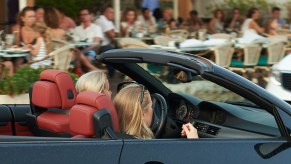 Two teen drivers cruise around in a car.