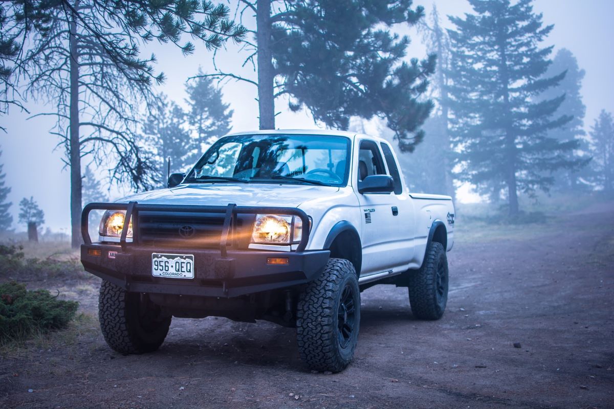 White Toyota pickup truck with bullbar on the front and Colorado plates