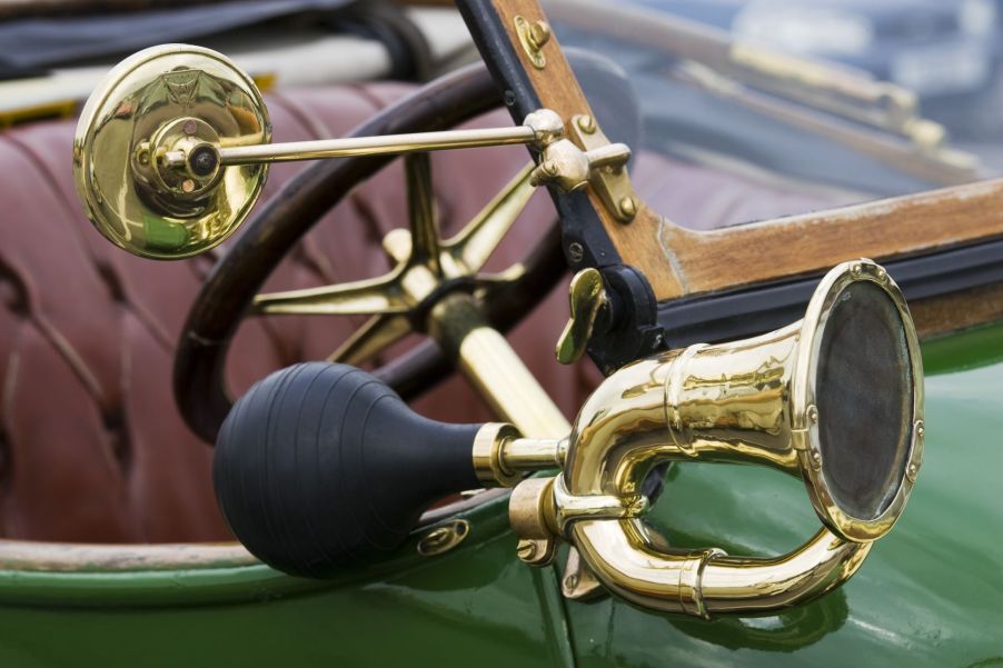 A vintage bulb car horn on a 1912 Renault car seen in the United Kingdom