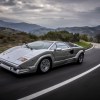 A silver 1989 Lamborghini Countach 25th Anniversary Edition driving around a mountain road