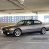 A gray 2000 E38 BMW 740i M Sport in a city parking garage