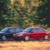 A red and a black 2000 Ford Contour SVT drive down a country road