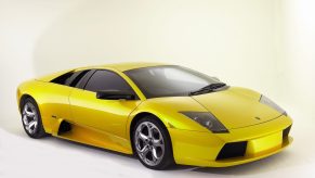 A yellow 2003 Lamborghini Murcielago in a white studio