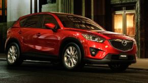 A red 2014 Mazda CX-5 at night.