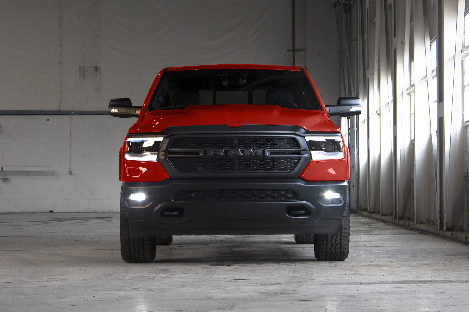 Red Ram 1500 pickup truck parked inside a garage.