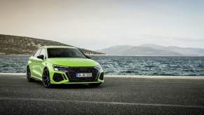 A bright-green 2022 Audi RS3 by the ocean