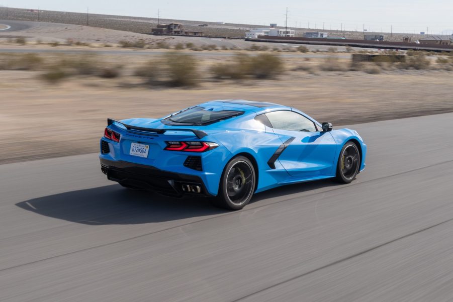 The rear 3/4 view of a blue 2022 Chevrolet C8 Corvette Stingray speeding down a desert track