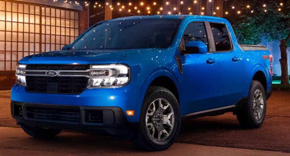 A blue 2022 Ford Maverick small pickup truck is parked outside.