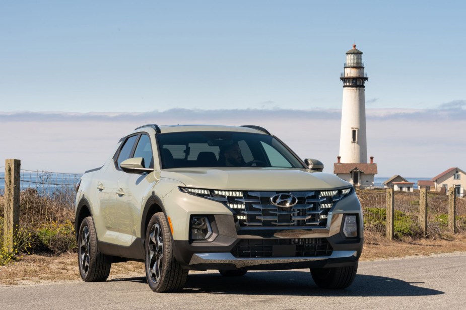 The 2022 Hyundai Santa Cruz compact pickup truck/sport adventure vehicle parked near a lighthouse