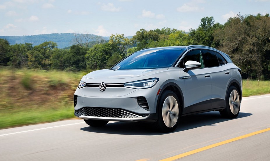 A light blue 2022 Volkswagen ID.4 driving down a road. 