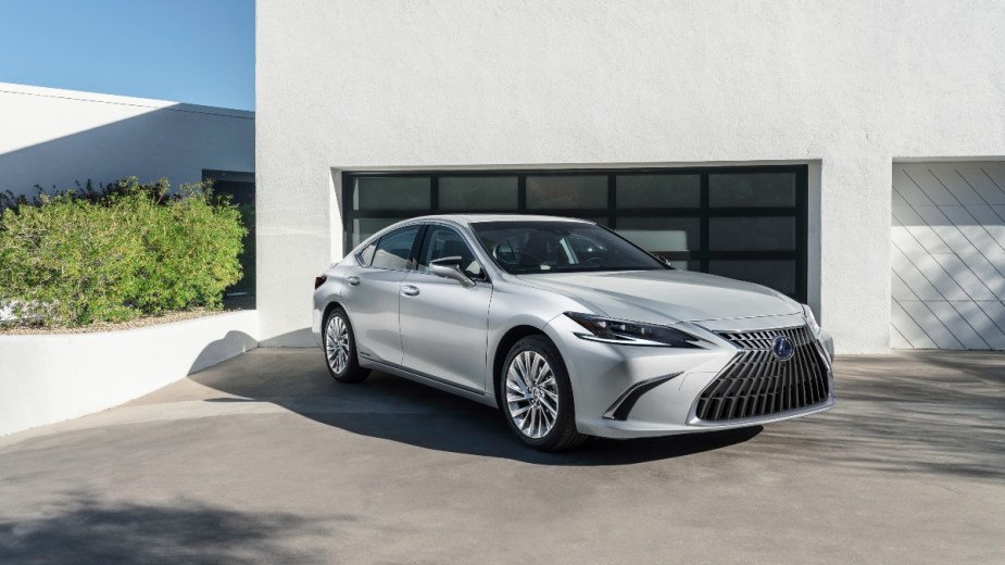 a silver 2022 lexus es 350 parked in front of a garage