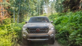 Nissan Frontier Pro-4X 4x4 truck speeding through the woods.