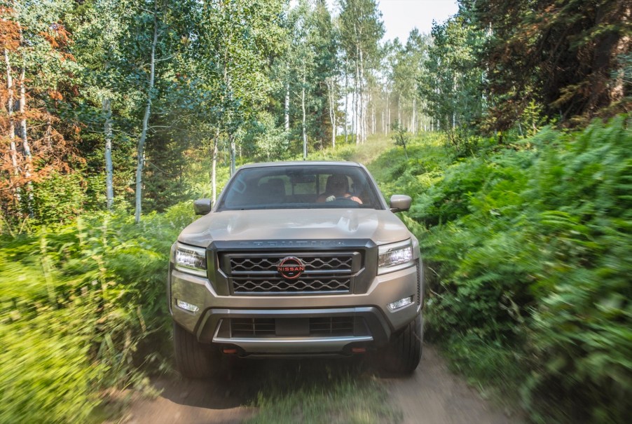 Nissan Frontier Pro-4X 4x4 truck speeding through the woods.