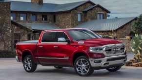 Red Ram truck parked in front of a mansion.