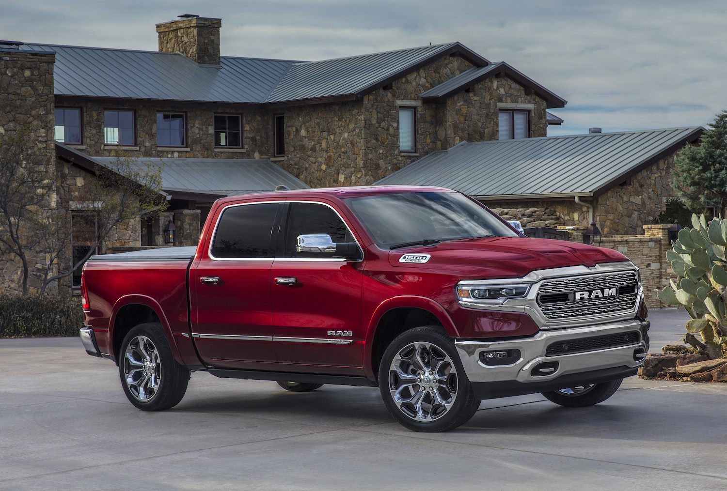 Red Ram truck parked in front of a mansion.