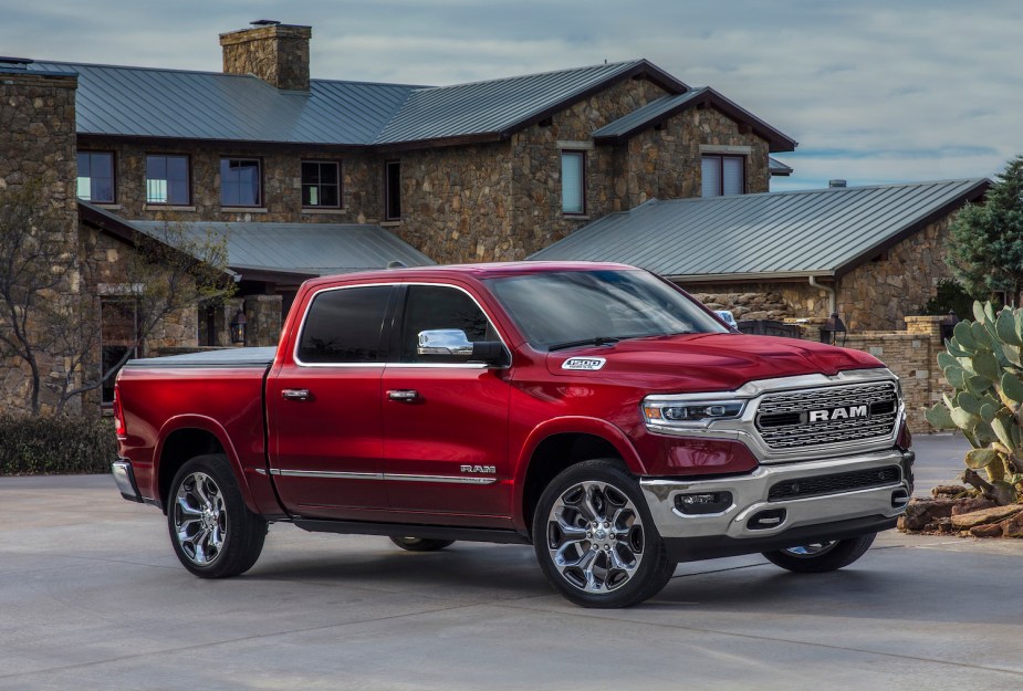 Red Ram truck parked in front of a mansion.