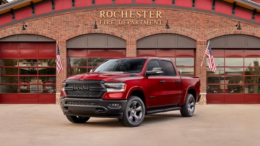 Red Ram 1500 pickup truck parked in front of a fire station.