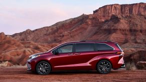 A red 2022 Toyota Sienna in a desert area.