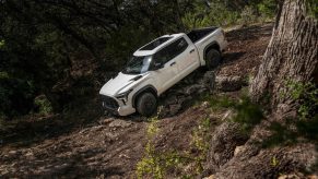 White Toyota Tundra pickup truck on an off-road trail.