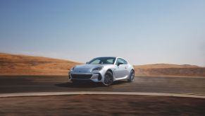 Silver 2022 Subaru BRZ Limited sports coupe drifting around a corner