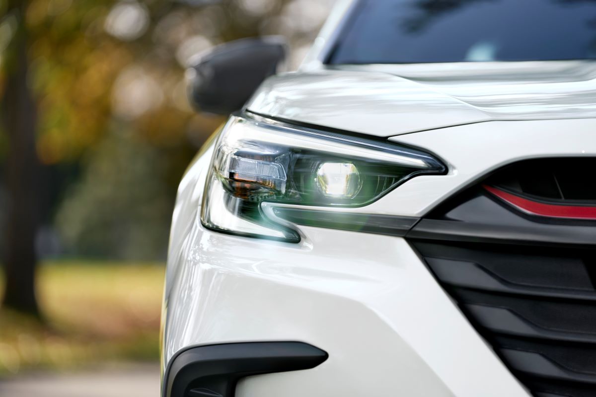 Close up view of the 2023 Subaru Legacy Sport in white. The red accented grille is visible