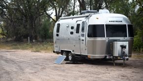 An Airstream travel trailer with solar panel kit parked in Ojo Caliente, New Mexico