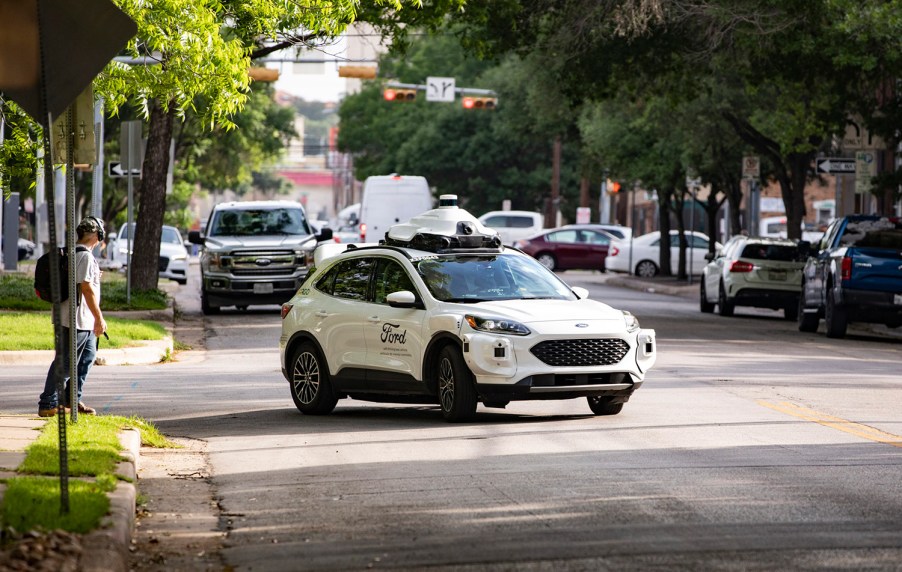 An Argo AI full self-driving taxi and delivery Ford Escape on public roads in Austin, Texas