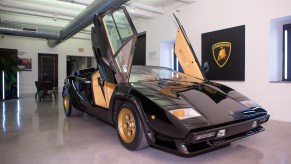 Black Lamborghini Countach with scissor doors up on display at Lamborhgini exhibit