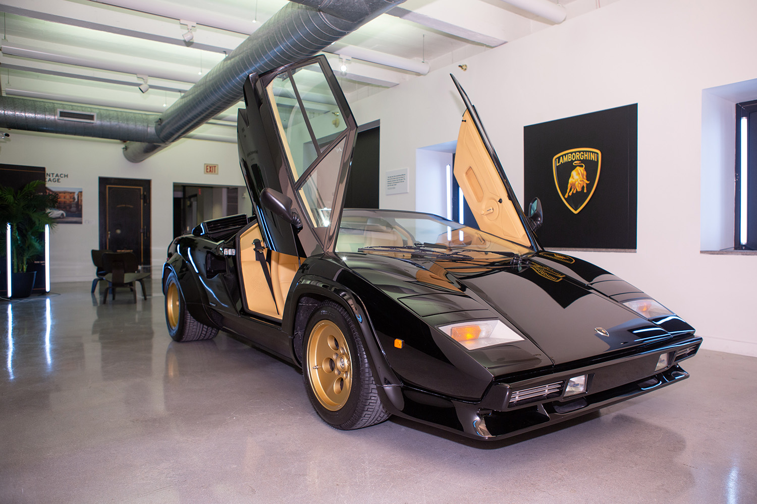 Black Lamborghini Countach  with scissor doors up on display at Lamborhgini exhibit 