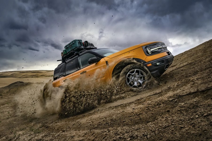 A yellow 2022 Ford Bronco Sport shows off its capability as an off-road SUV.