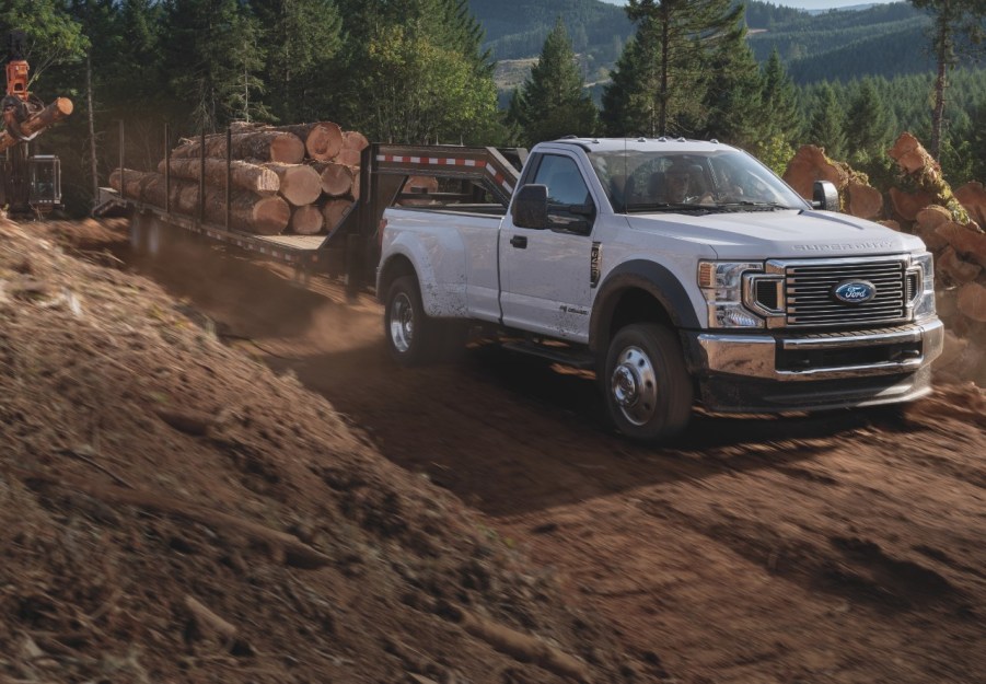 A Ford F-450 towing logs