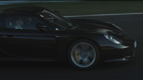 Black Porsche Carrera GT driving on Nürburgring in Germany