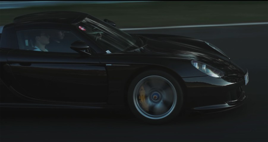 Black Porsche Carrera GT driving on Nürburgring in Germany