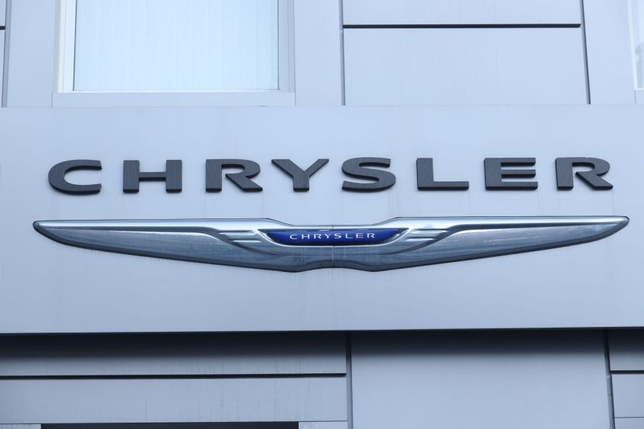 A Chrysler logo, one of the easiest cars to find during the chip shortage, on a white building.