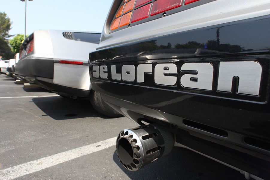 Delorean written on the bumper of a classic grey Delorean car.