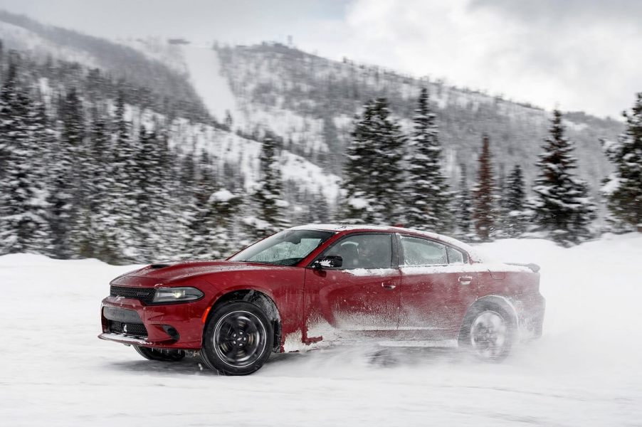 A red Dodge Charger GT AWD kicks up snow.