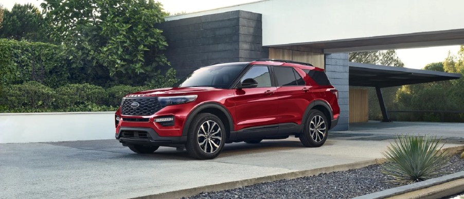 A red 2022 Ford Explorer parked outside of a house.