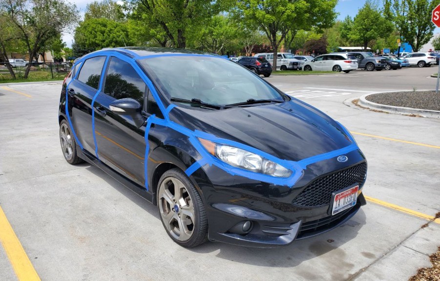 2016 Ford Fiesta ST covered in masking tape in an attempt to test fuel economy hacks for improving mpgs on road trip