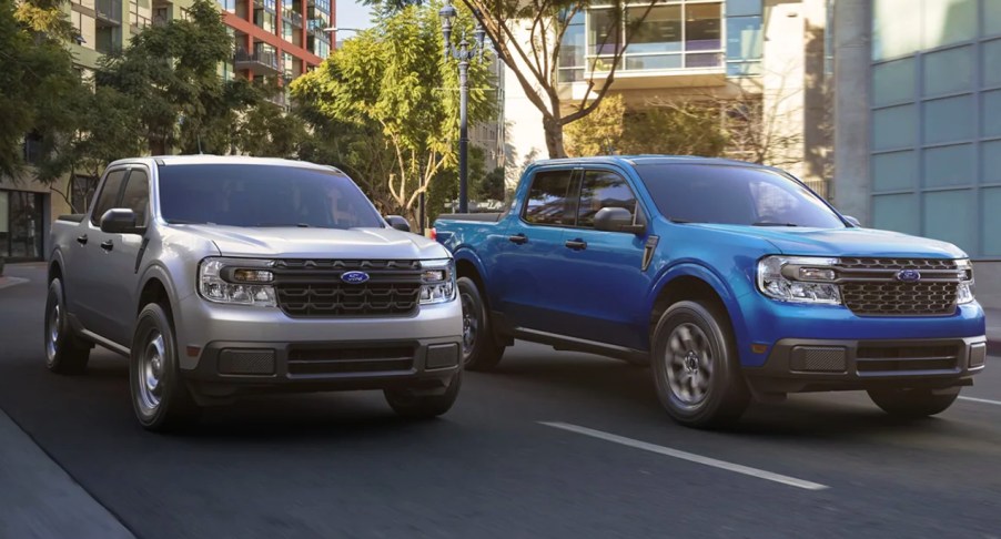 Two Ford Maverick small pickup trucks are driving on the road.