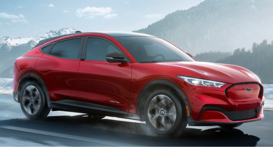 A 2022 Ford Mustang Mach-E electric SUV is driving on the road.